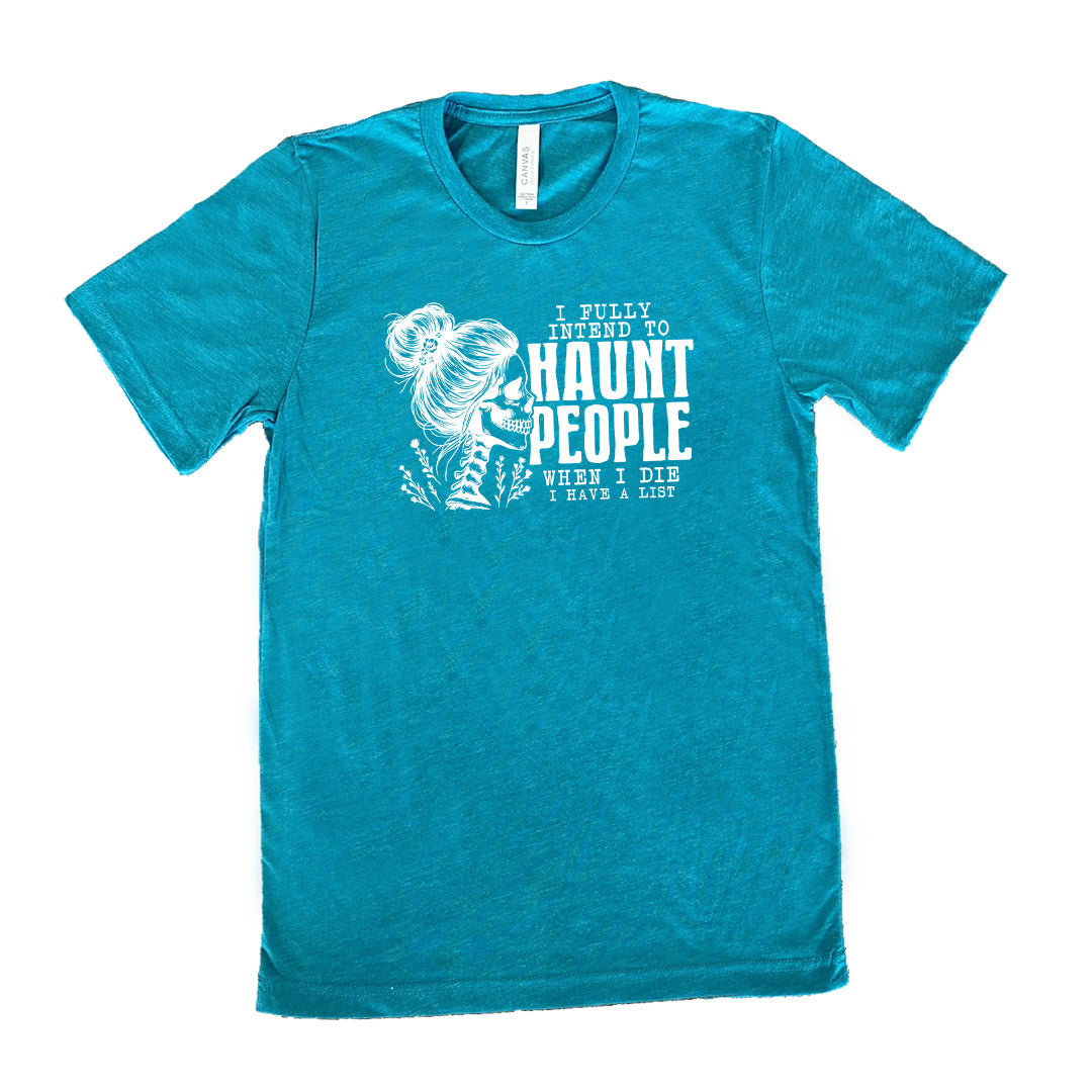 Teal colored shirt with smiling female skeleton graphic on it that says "I Fully Intend To Haunt People When I Die I Have A List"