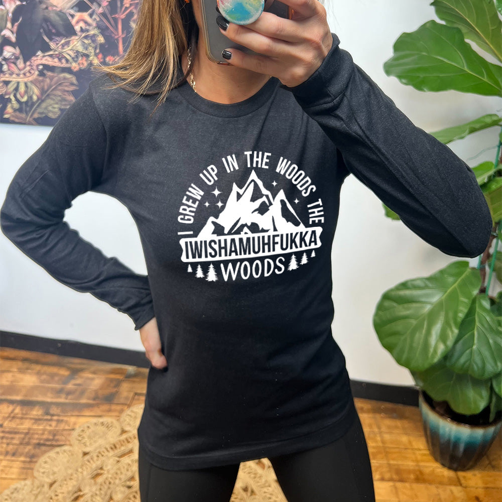 heather black long sleeve with the words "I grew up in the woods the Iwishamuhfukka woods" on it, with the graphic of mountains and trees and stars