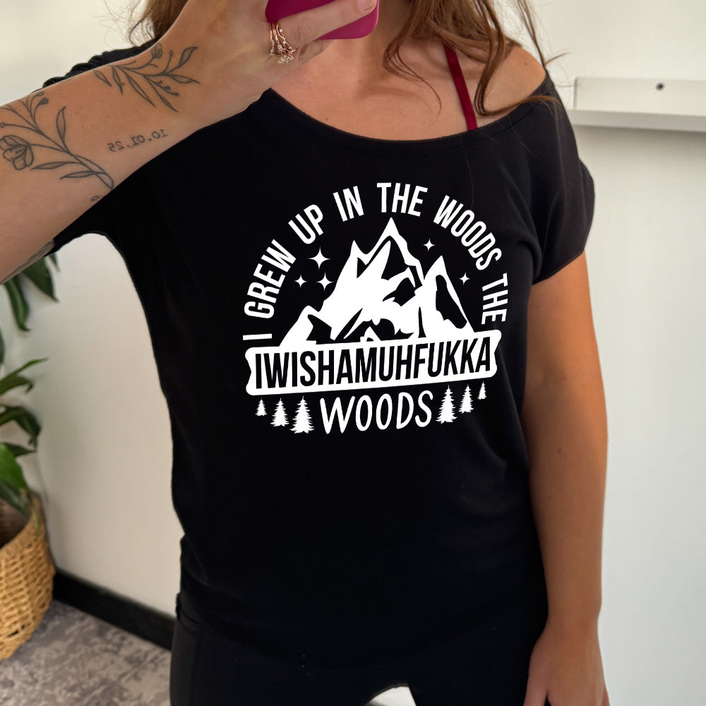 black slouchy tee with the words "I grew up in the woods the Iwishamuhfukka woods" on it, with the graphic of mountains and trees and stars