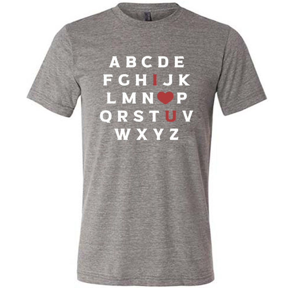 grey unisex tee with the alphabet on it in white lettering, but with the "I" in red, the "O" turned into a red heart, and "U" in red