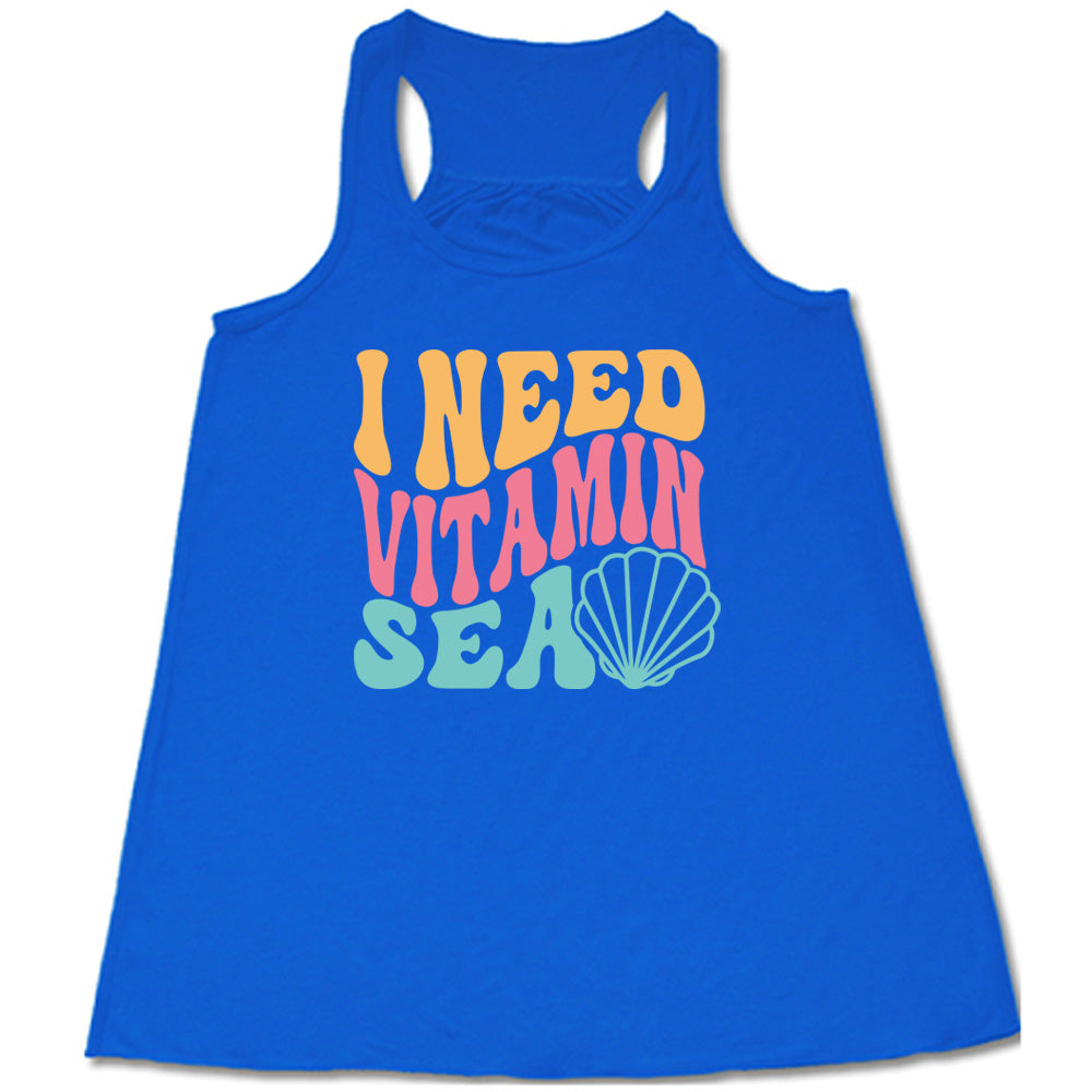 Blue colored flowy tank with a shell graphic on it that says "I Need Vitamin Sea" 