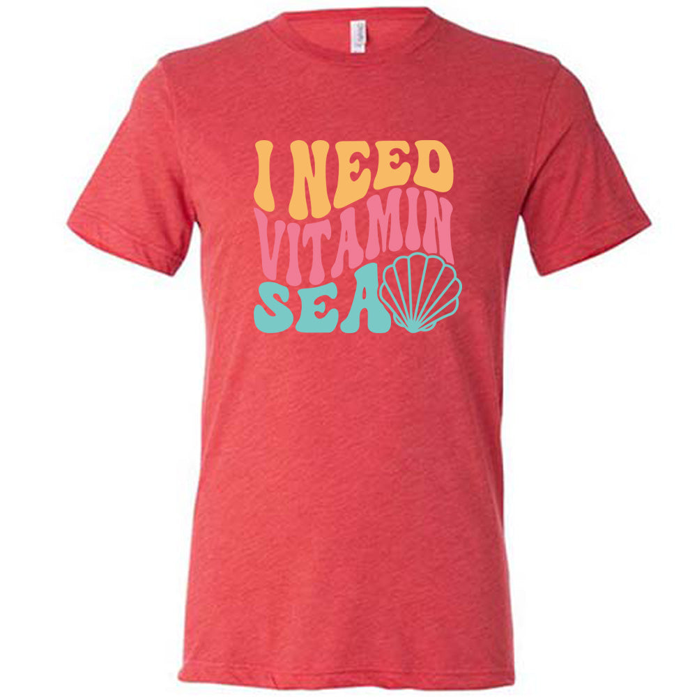 Red colored shirt with a shell graphic on it that says "I Need Vitamin Sea" 