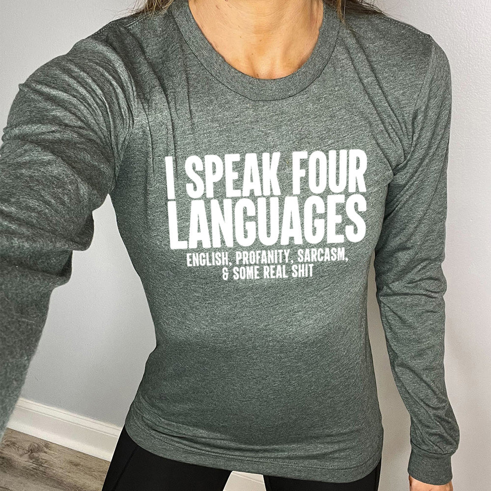 heather forest long sleeve shirt with the words "I speak four languages" in big letters, and smaller words underneath saying "English, profanity, sarcasm, & some real shit"
