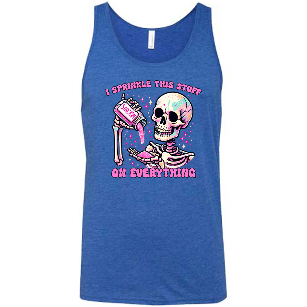 blue unisex tank with the words "I sprinkle this stuff on everything" on it, and the graphic of a skeleton who is pouring a jar labeled "sarcasm" filled with pink glittery material into its hand, surrounded by little pink and white stars