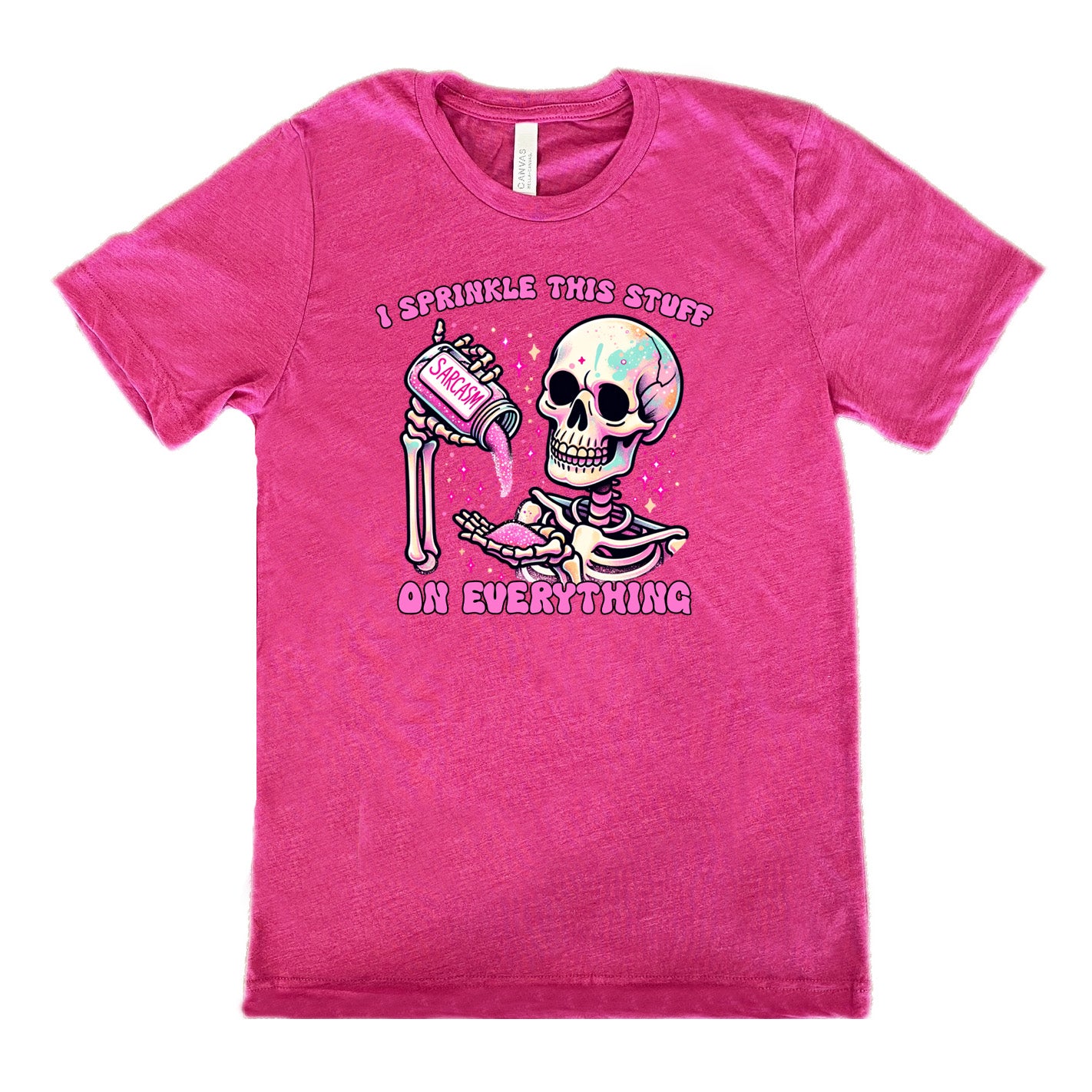berry unisex tee with the words "I sprinkle this stuff on everything" on it, and the graphic of a skeleton who is pouring a jar labeled "sarcasm" filled with pink glittery material into its hand, surrounded by little pink and white stars