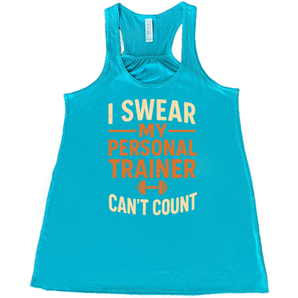 teal flowy tank with the words "I swear my personal trainer can't count" on it, and the small image of a barbell