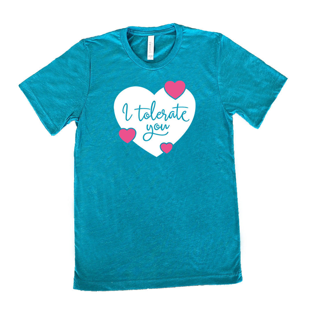 teal unisex tee with the words "I tolerate you" in teal lettering on it, within a white heart graphic that has three small pink hearts overlapping on its edges 