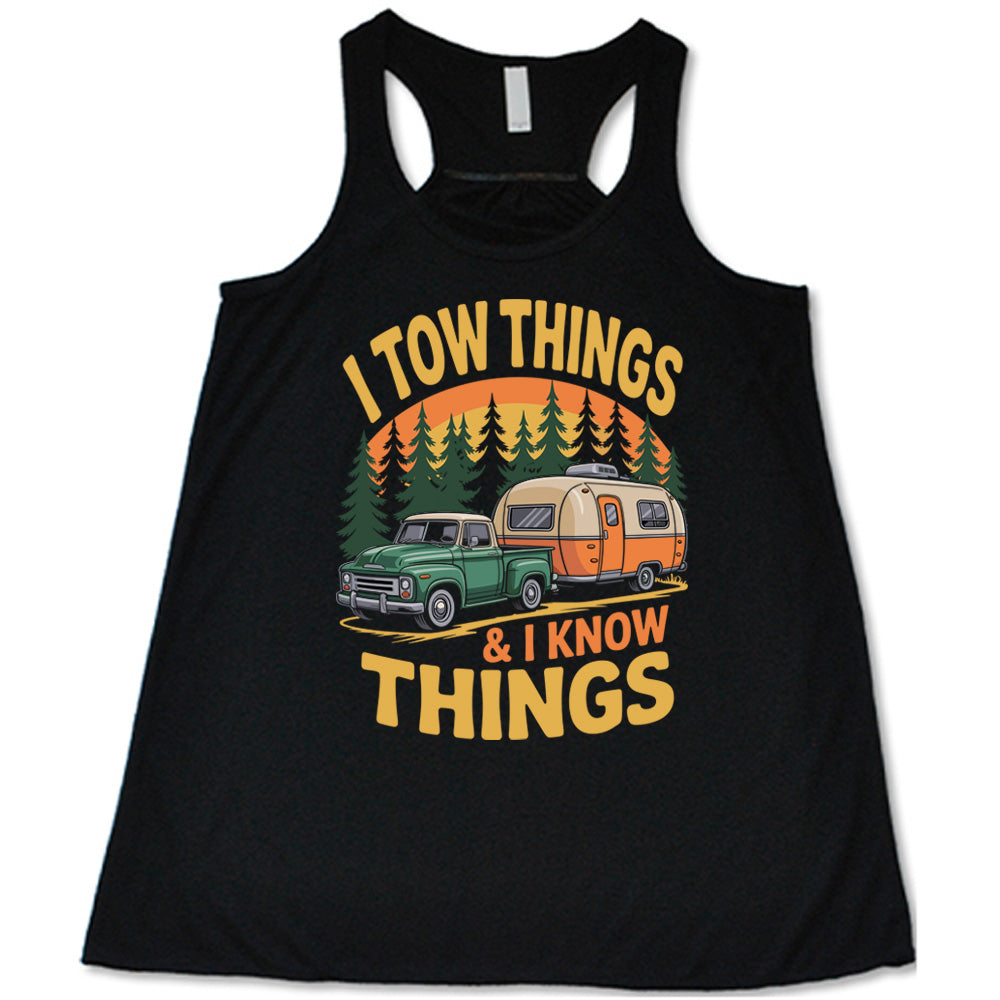 black flowy tank with the words "I tow things & I know thing" on it, with the graphic of an old-fashioned truck pulling a camper on a road lined with tall trees