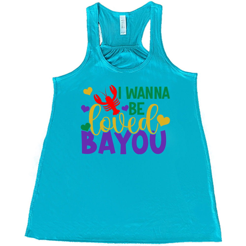 teal flowy tank with the words "I wanna be loved bayou" on it in varied fonts, with the small graphics a few hearts and one lobster