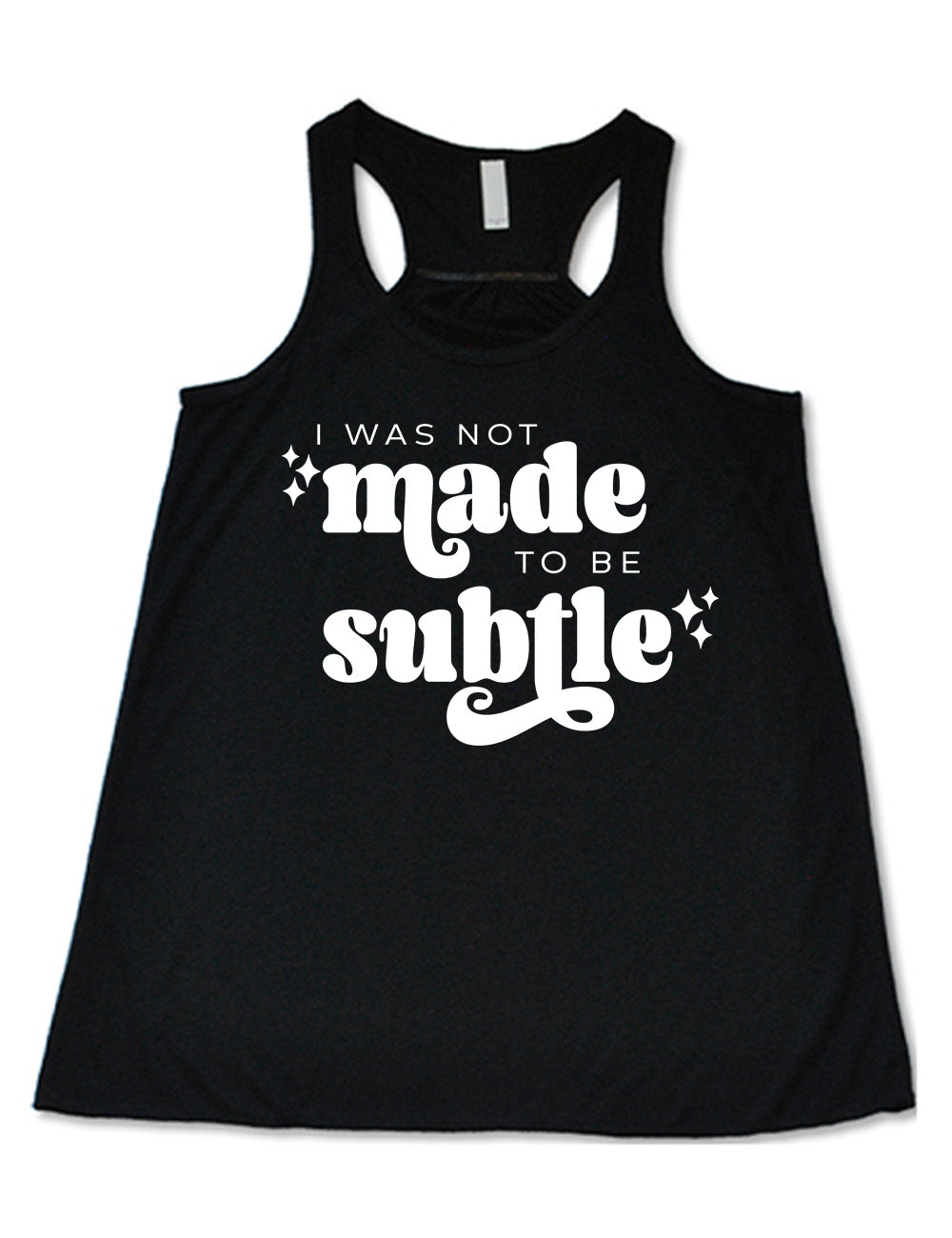 black flowy racerback tank with the words "I was not made to be subtle" on it, with a few stars embellishing