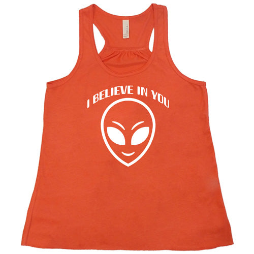 coral racerback tank top with a "I believe in you" quote and alien head design on it