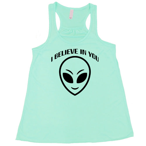 mint racerback tank top with a "I believe in you" quote and alien head design on it