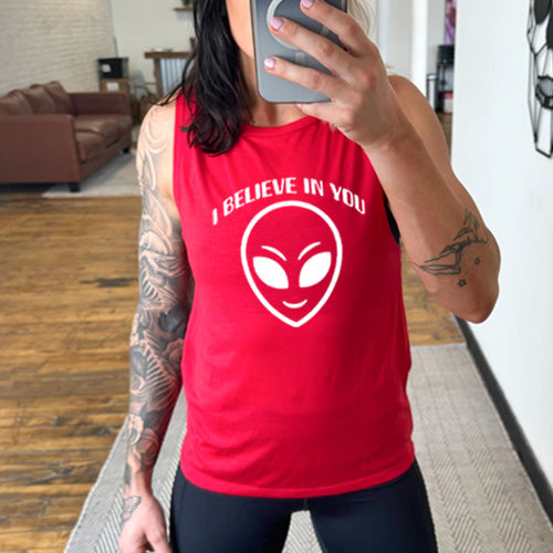 red muscle tank top with a "I believe in you" quote and alien head design on it