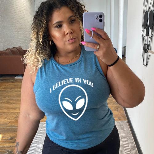 deep teal muscle tank top with a "I believe in you" quote and alien head design on it
