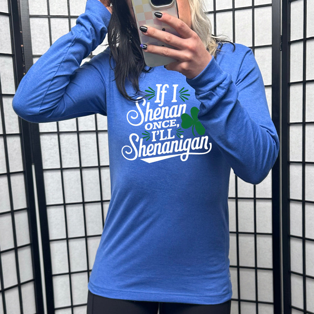 heather true royal long sleeve with the words "if I shenan once, I'll shenanigan" on it, with the graphic of a shamrock