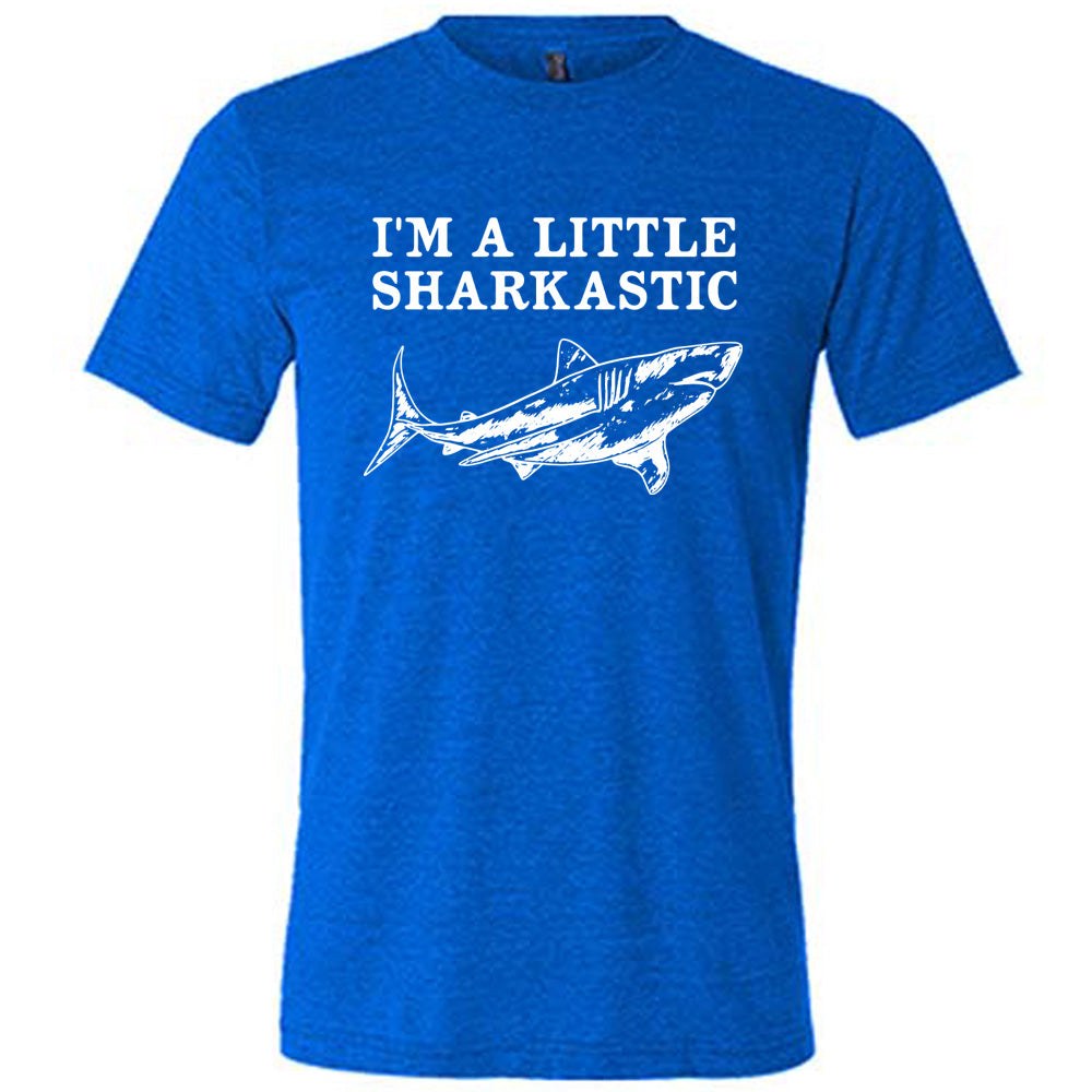 blue unisex tee with the words "I'm a little sharkastic" on it, over the graphic of a shark