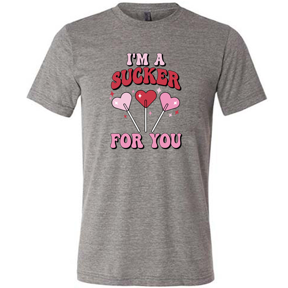 grey shirt with the text "I'm A Sucker For You" on it