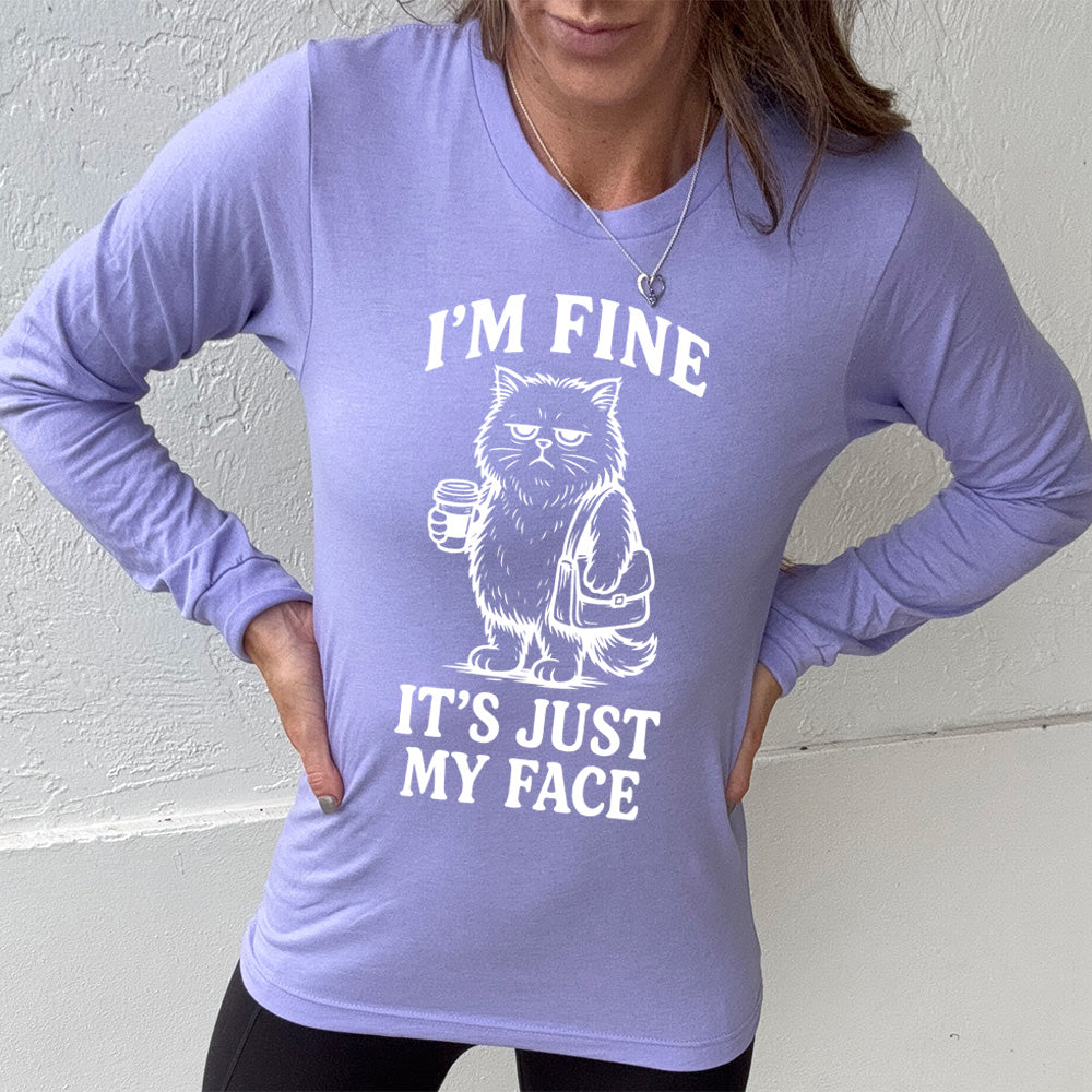heather dark lavender long sleeve shirt with the words "I'm fine it's just my face" on it, around the graphic of a cat with a resting-grumpy face, holding a coffee and wearing a purse
