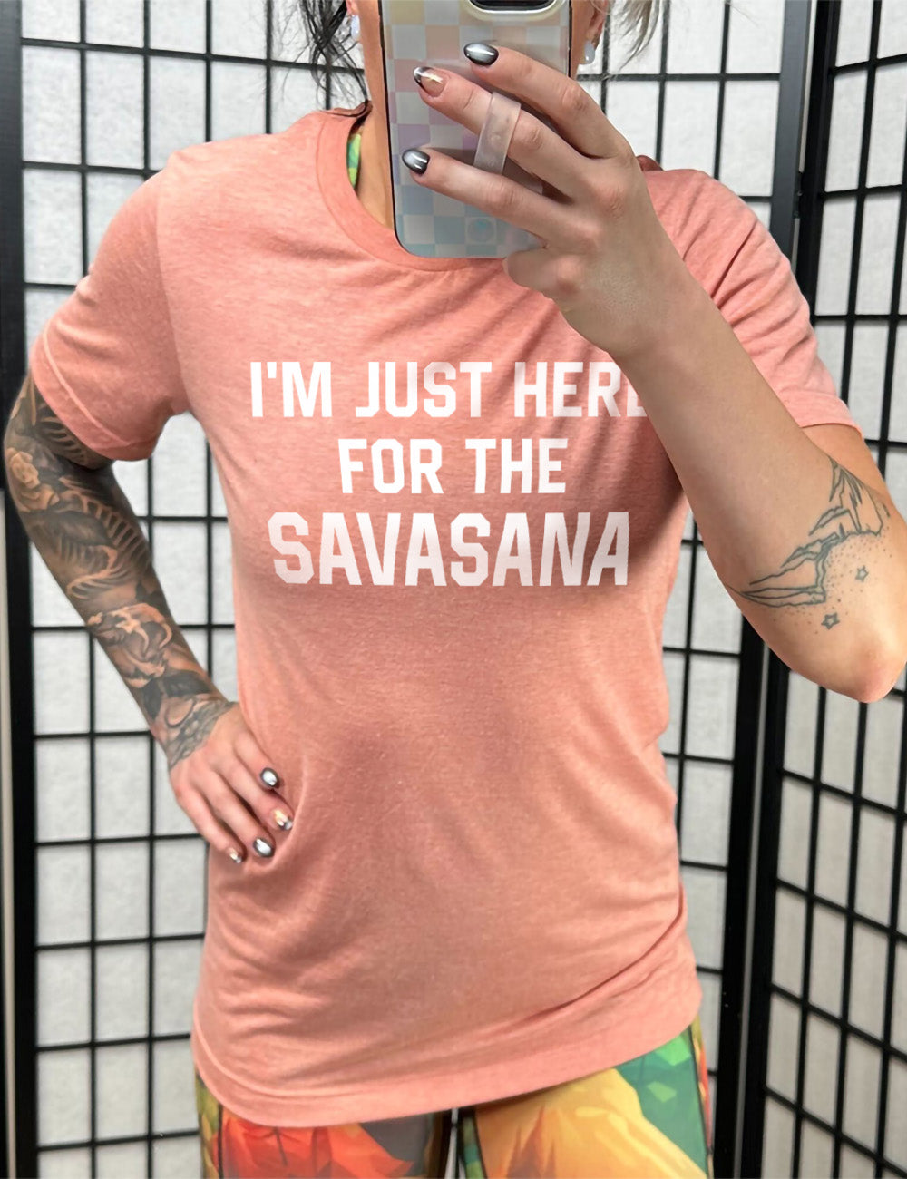 sunset unisex tee with the words "I'm just here for the savasana" on it