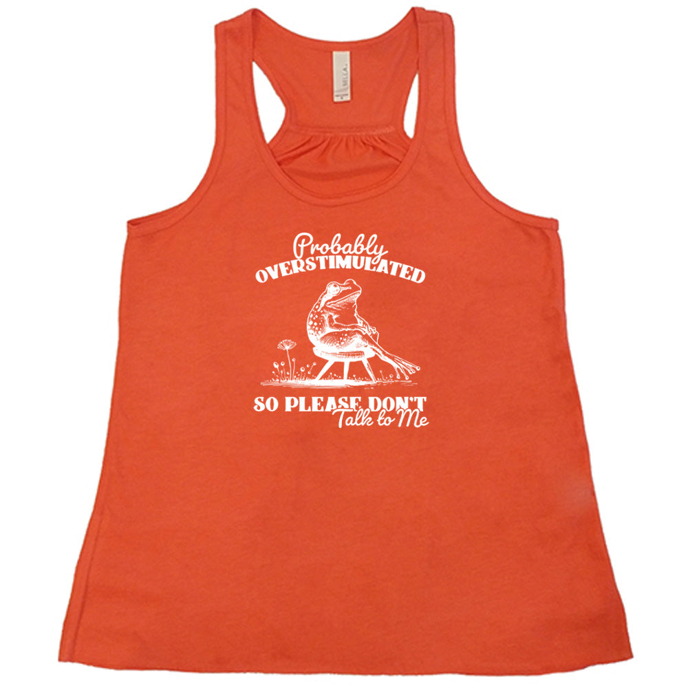 Coral colored flowy tank with a frog on a chair graphic on it that says "Probably Overstimulated So Please Don't Talk to Me" 