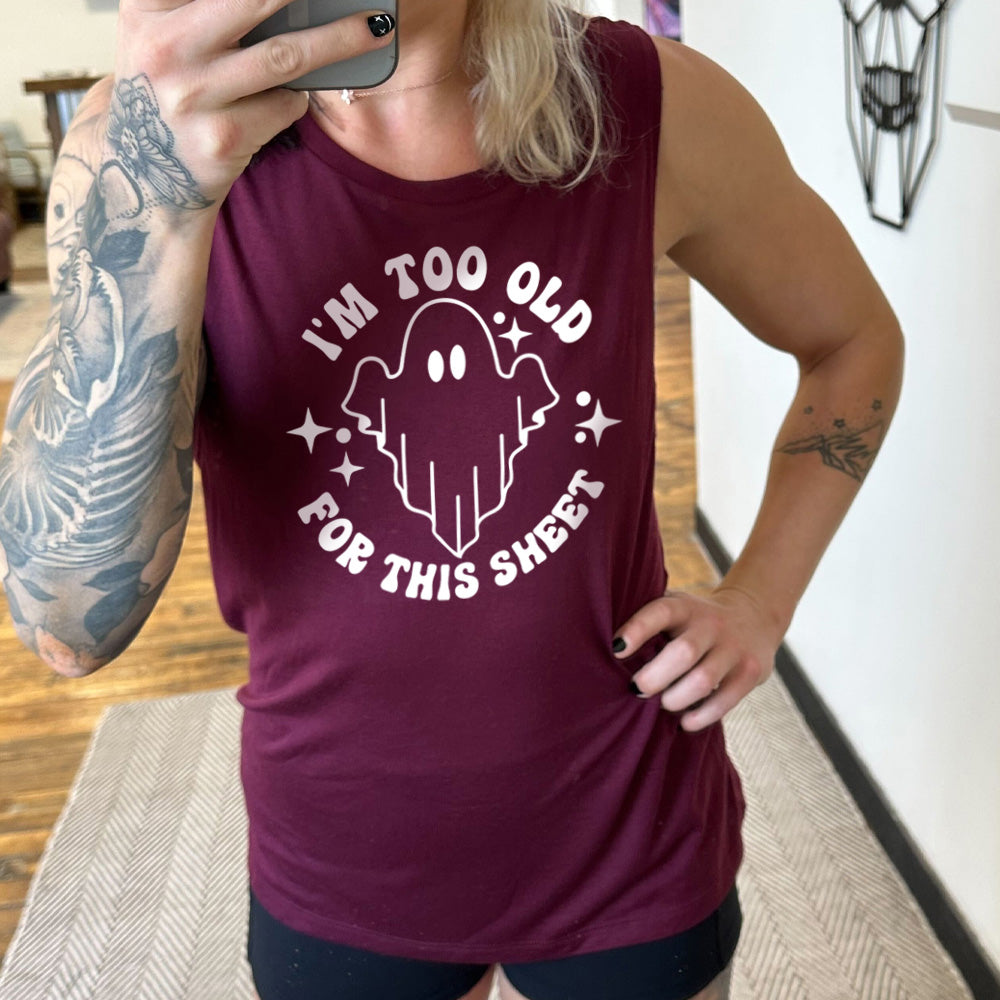 Model wearing maroon colored muscle tank with ghost graphic on it that says "I'm Too Old For This Sheet"