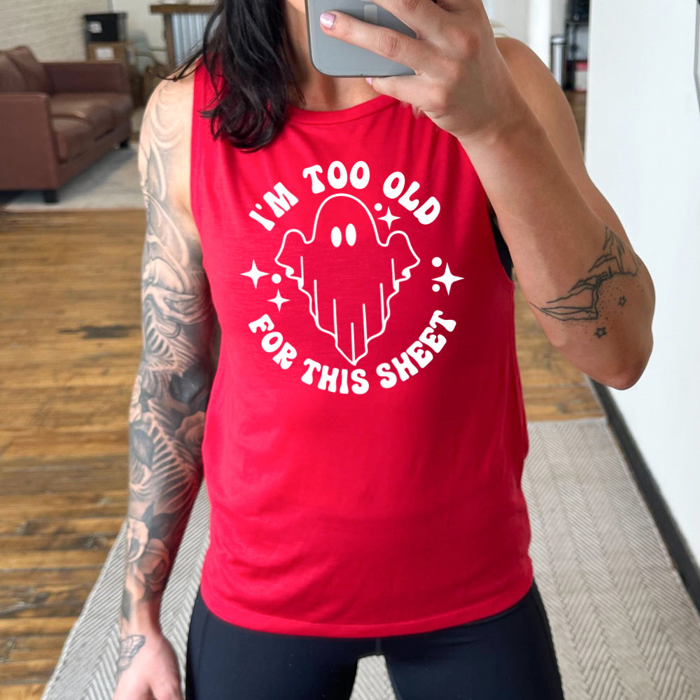 Model wearing red colored muscle tank with ghost graphic on it that says "I'm Too Old For This Sheet"
