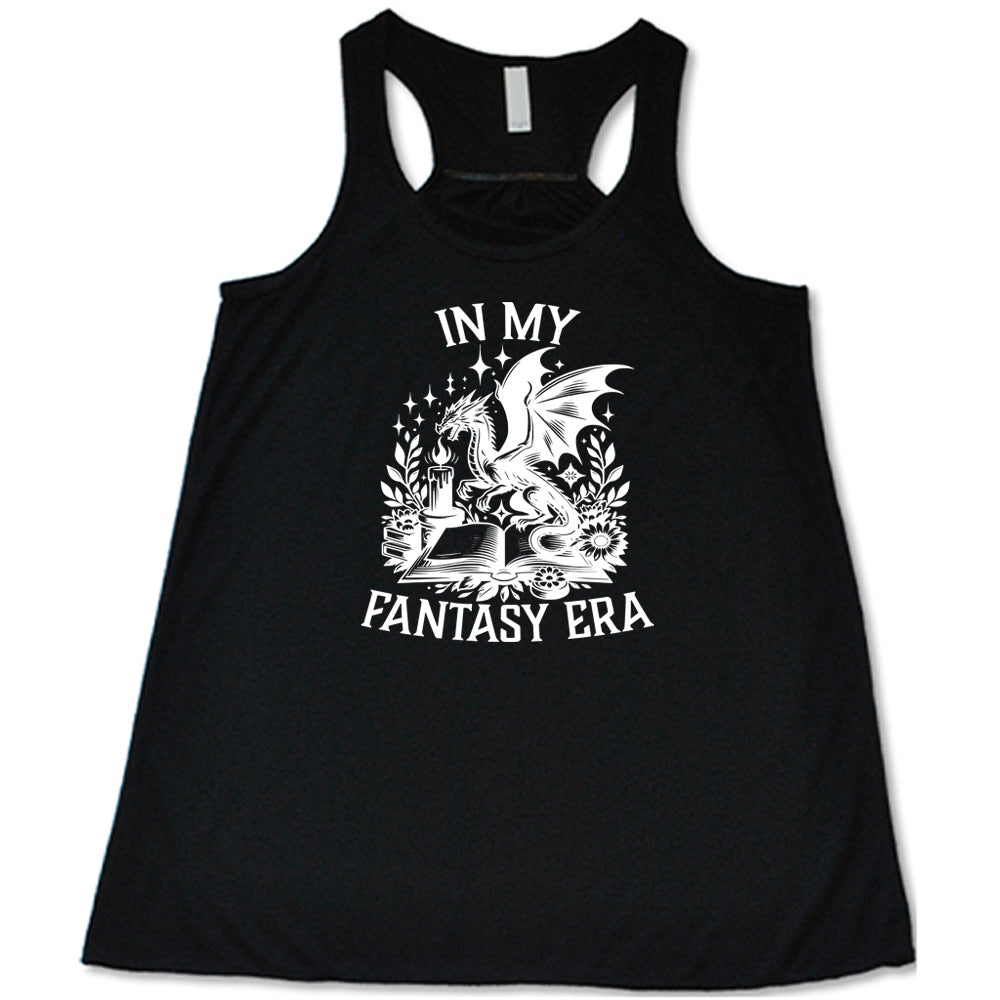 Black colored flowy tank with a dragon lighting a candle over a book graphic on it that says "In My Fantasy Era" 