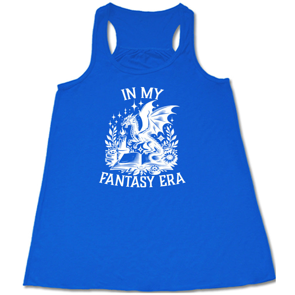 Blue colored flowy tank with a dragon lighting a candle over a book graphic on it that says "In My Fantasy Era" 