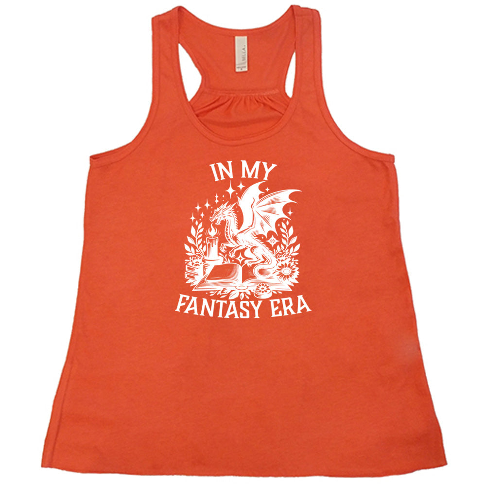 Coral colored flowy tank with a dragon lighting a candle over a book graphic on it that says "In My Fantasy Era" 