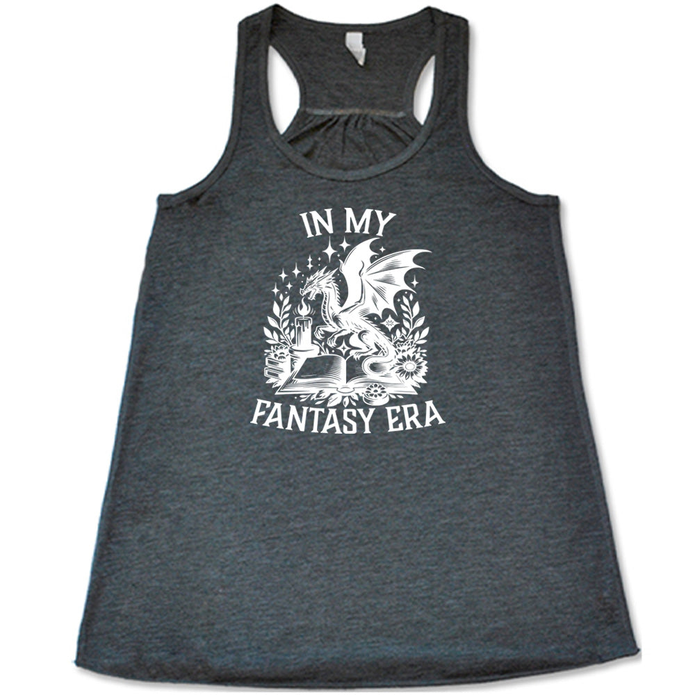 Grey colored flowy tank with a dragon lighting a candle over a book graphic on it that says "In My Fantasy Era" 