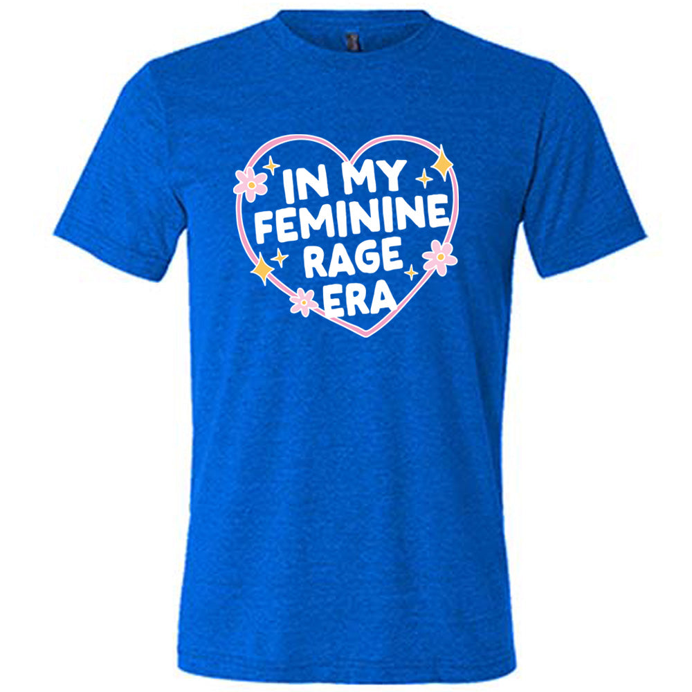 blue unisex tee with the words "in my feminine rage era" within a heart, with scattered flowers and stars