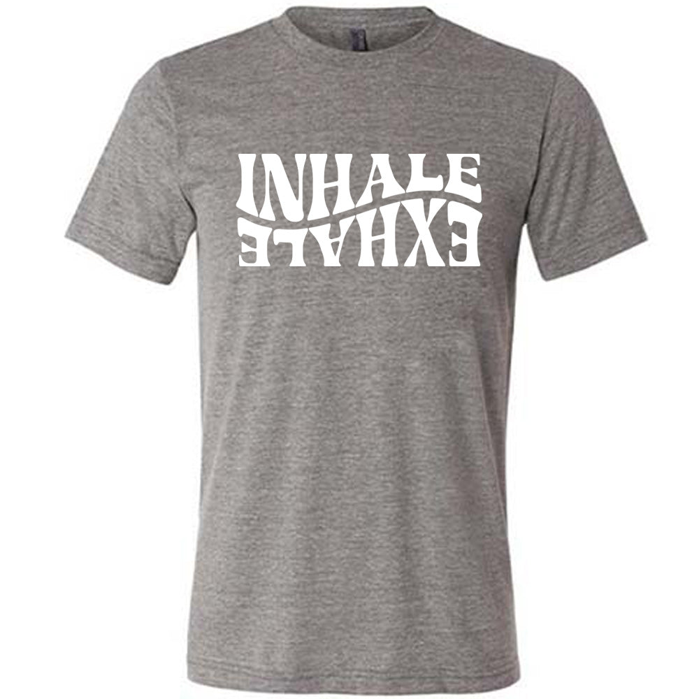 Grey unisex tee with the words "inhale exhale" on it, with the word "exhale" upside down and backwards, giving almost a yin and yang effect