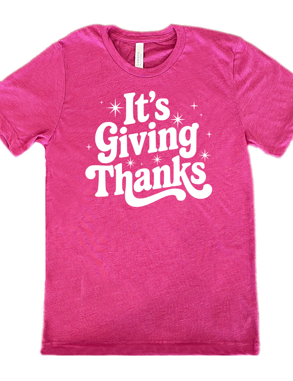berry unisex tee with the words "It's Giving Thanks" on it, surrounded by graphics of little stars