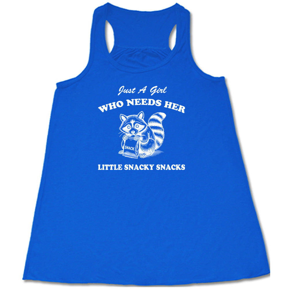 Blue colored flowy tank with a raccoon holding a snack graphic on it that says "Just a Girl Who Needs Her Little Snacky Snacks" 