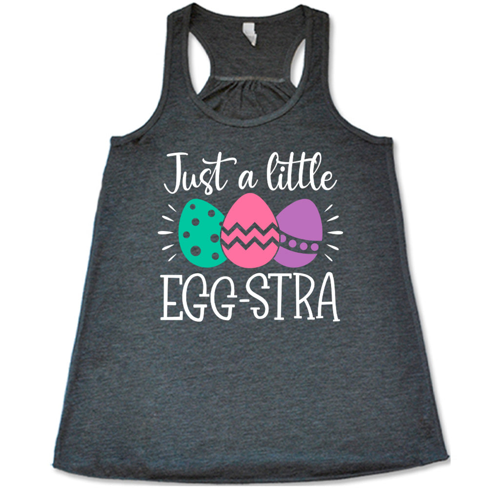 grey racerback tank with the words "just a little egg-stra" on it, with the graphic of three decorated easter eggs 