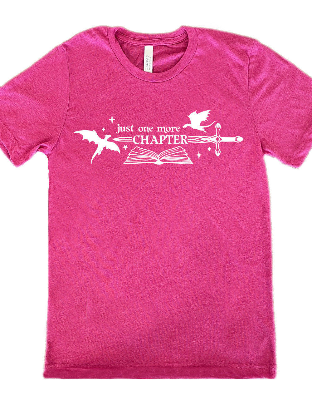 berry unisex tee with the graphic of an open book, with stars and a couple dragon silhouettes, and a sword, and the words "just one more chapter" on it, with the word "chapter" overlaying the sword