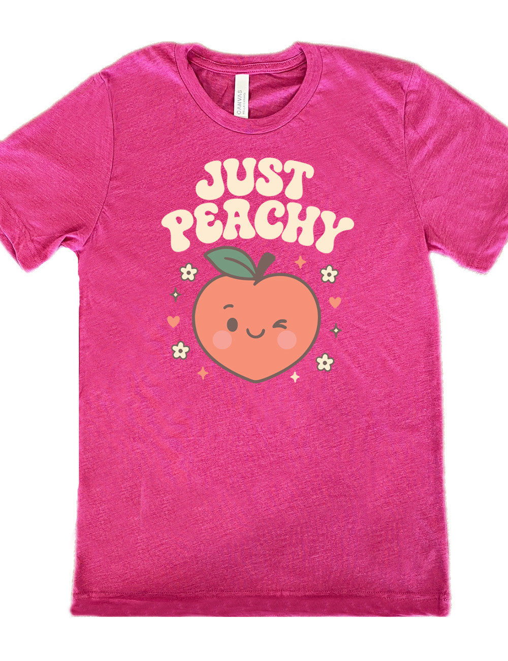 berry unisex tee with the graphic of a winking peach, surrounded by little hearts, flowers, and stars, with the words above it saying "just peachy"