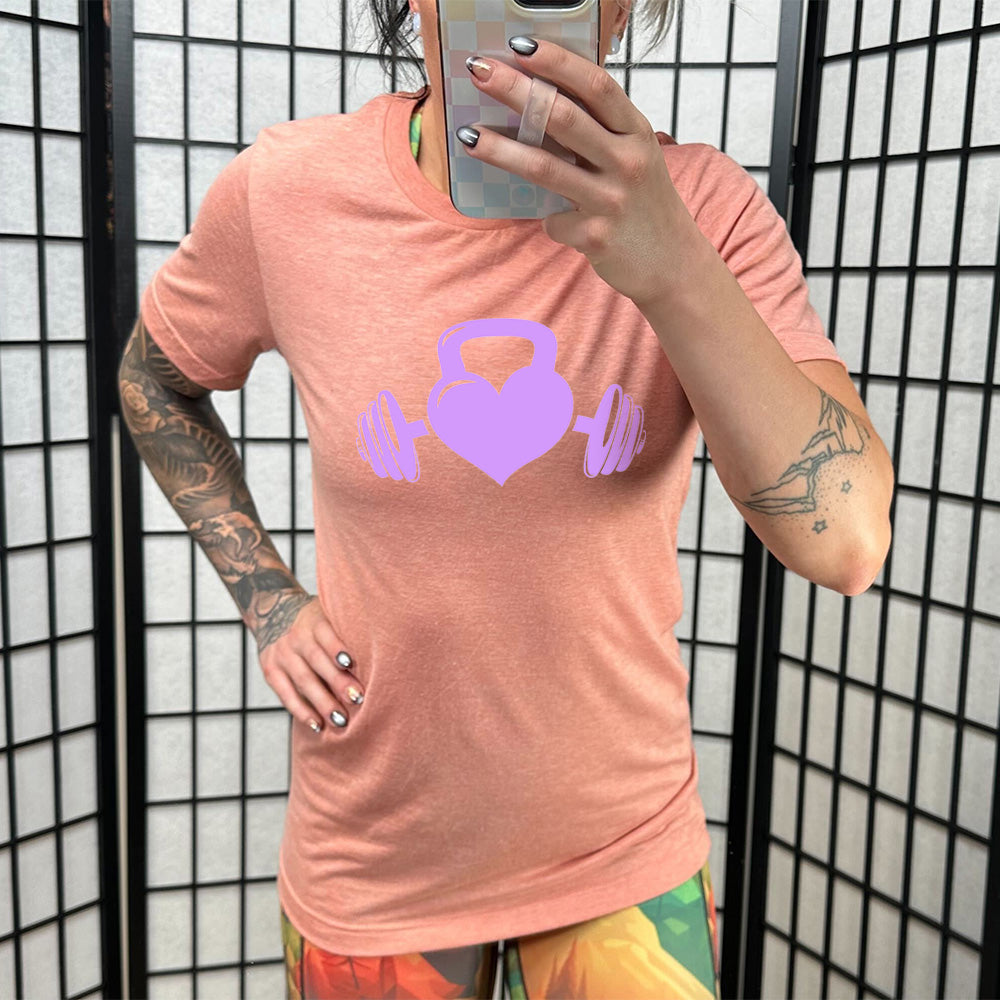 coral shirt with a light purple Kettlebell Heart graphic on it