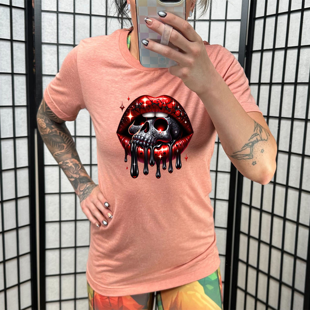 coral shirt with a skull and lip graphic on it