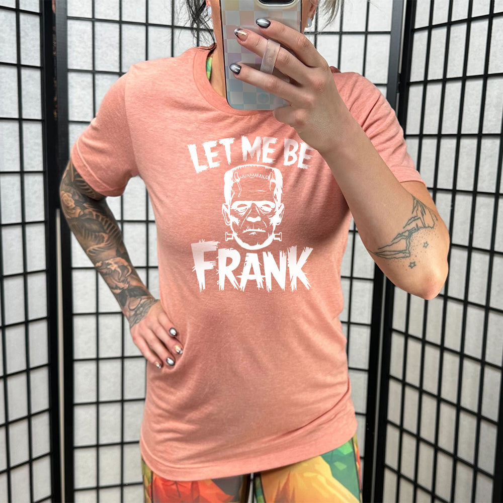 Model wearing sunset colored shirt with Frankenstein graphic on it that says "Let Me Be Frank" 