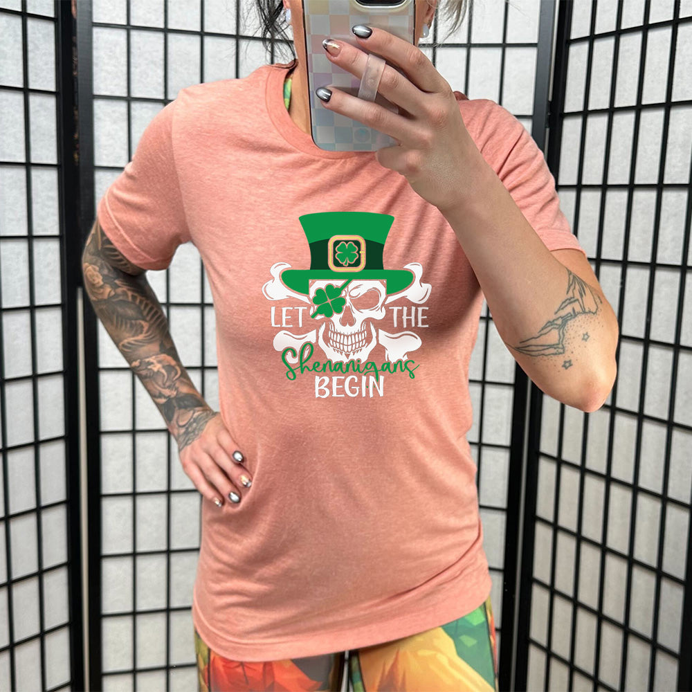 coral shirt with the quote "Let The Shenanigans Begin" on it