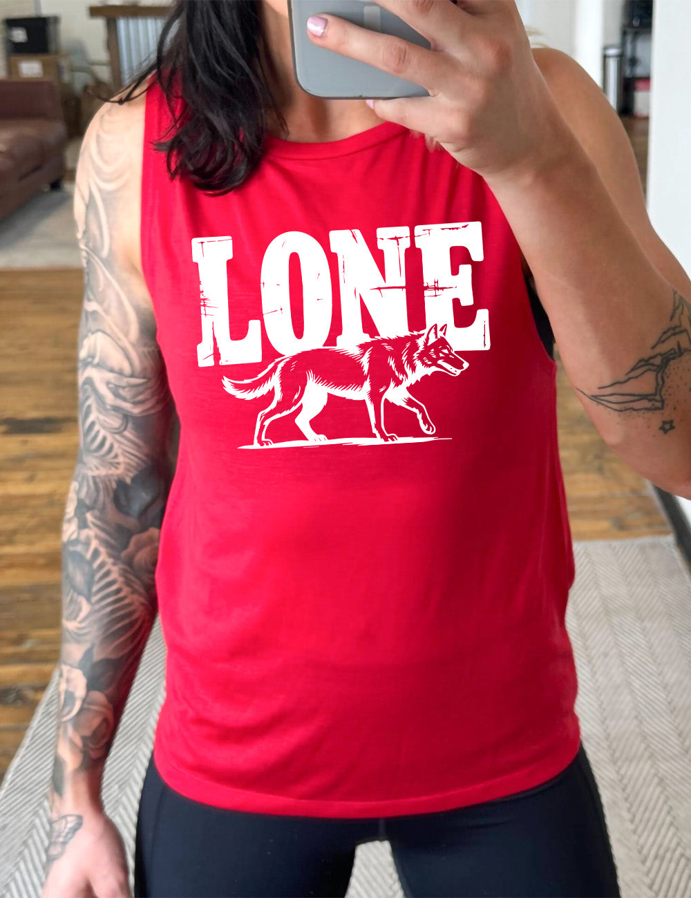 red muscle tank with the large all caps word "lone" on it, with a wolf graphic underneath