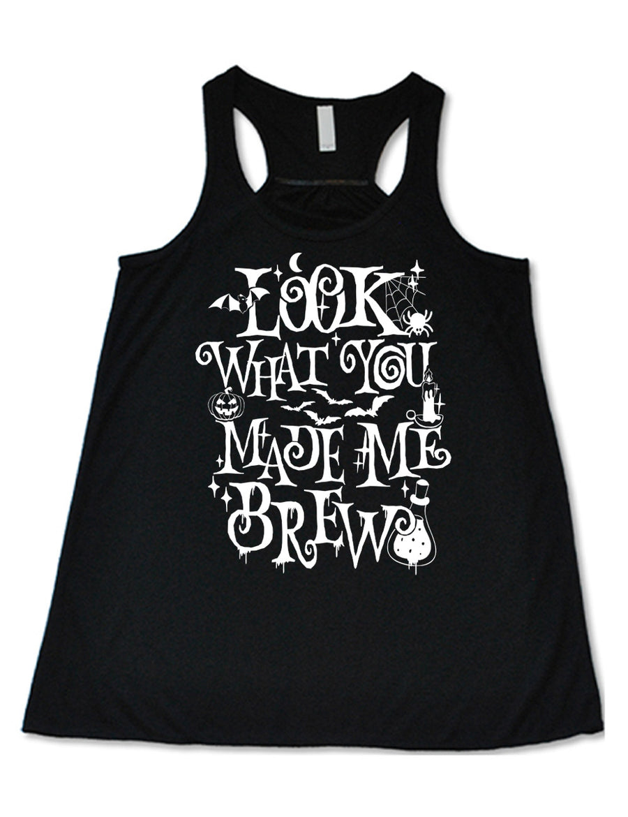 black flowy racerback tank with the curly, dripping words saying "look what you made me brew" (with the "o" being a spiral) and the graphics of a potion, a spider in its web, a candle, a bat some bats, stars, and a jack-o-lantern