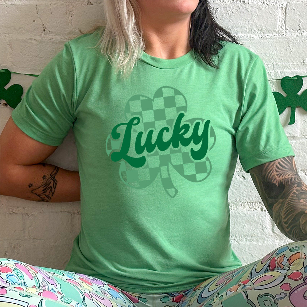 green shirt with a checkered shamrock graphic on it