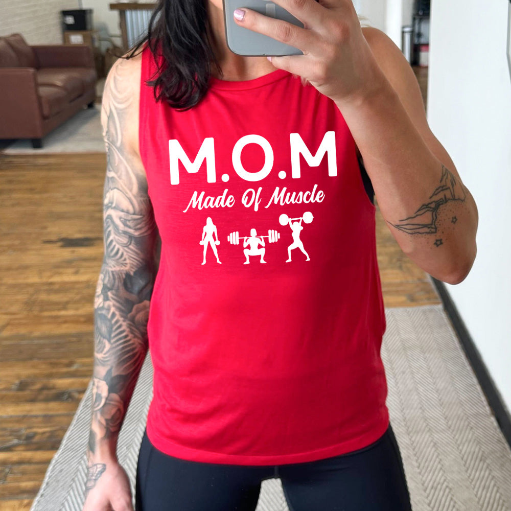 red muscle tank with the word "mom" in large letters as an acronym for the smaller words below it saying "made of muscle", and the graphic of three female silhouettes holding weights