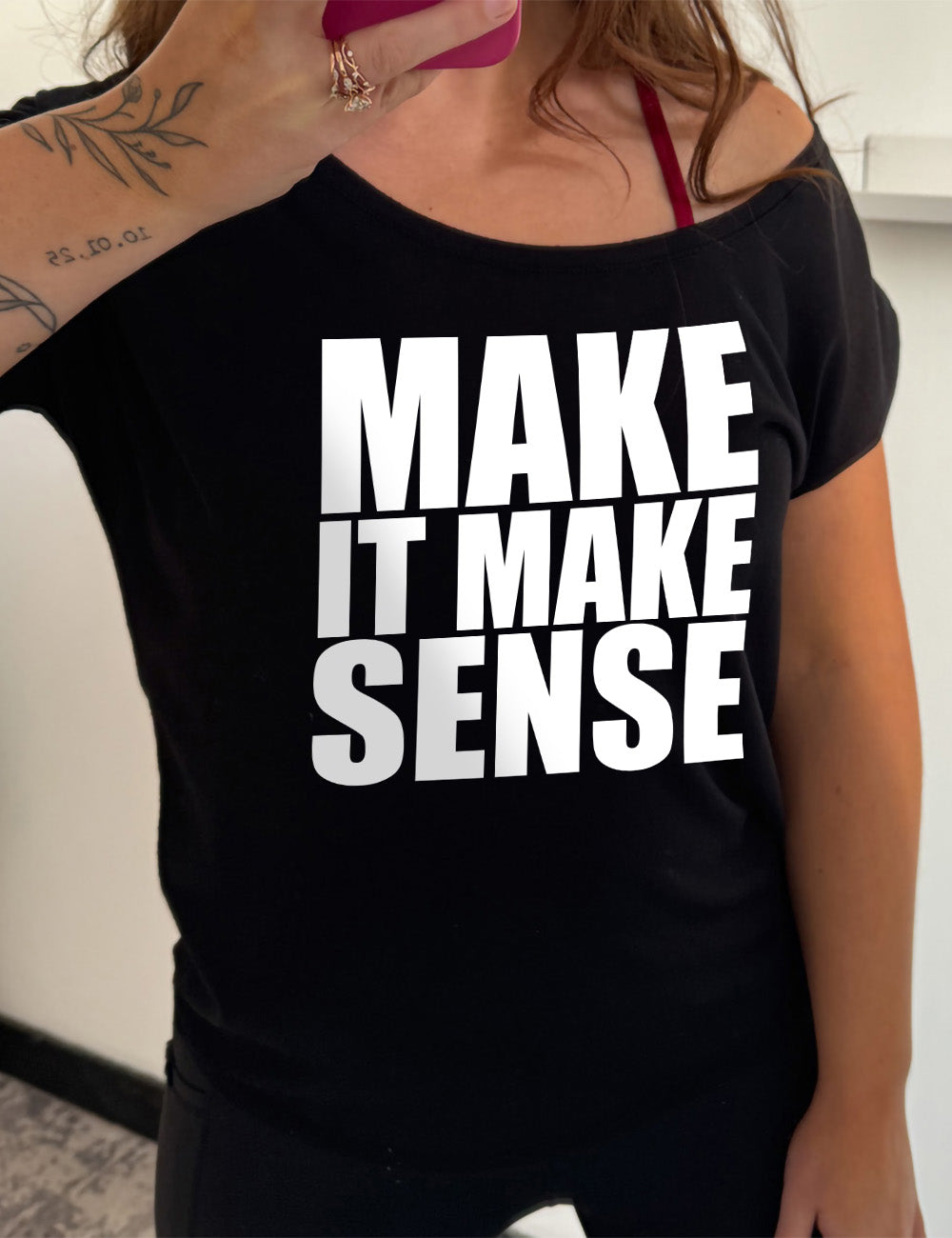 black slouchy tee with the words on it saying "make it make sense"