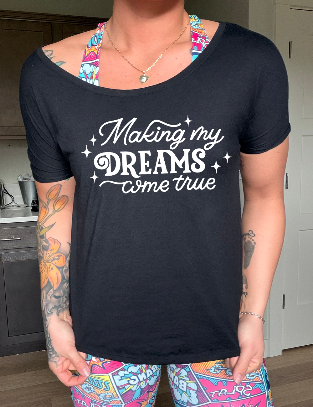 black slouchy tee with the words "making my dreams come true" on it, with a few little stars around it