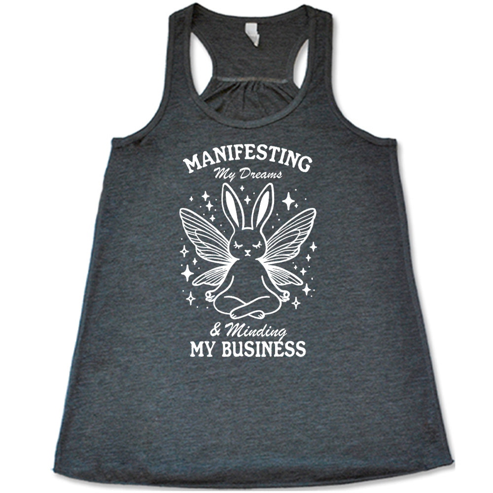 Grey flowy tank with the words "Manifesting My Dreams & Minding My Business" and the graphic of a meditating rabbit with butterfly wings