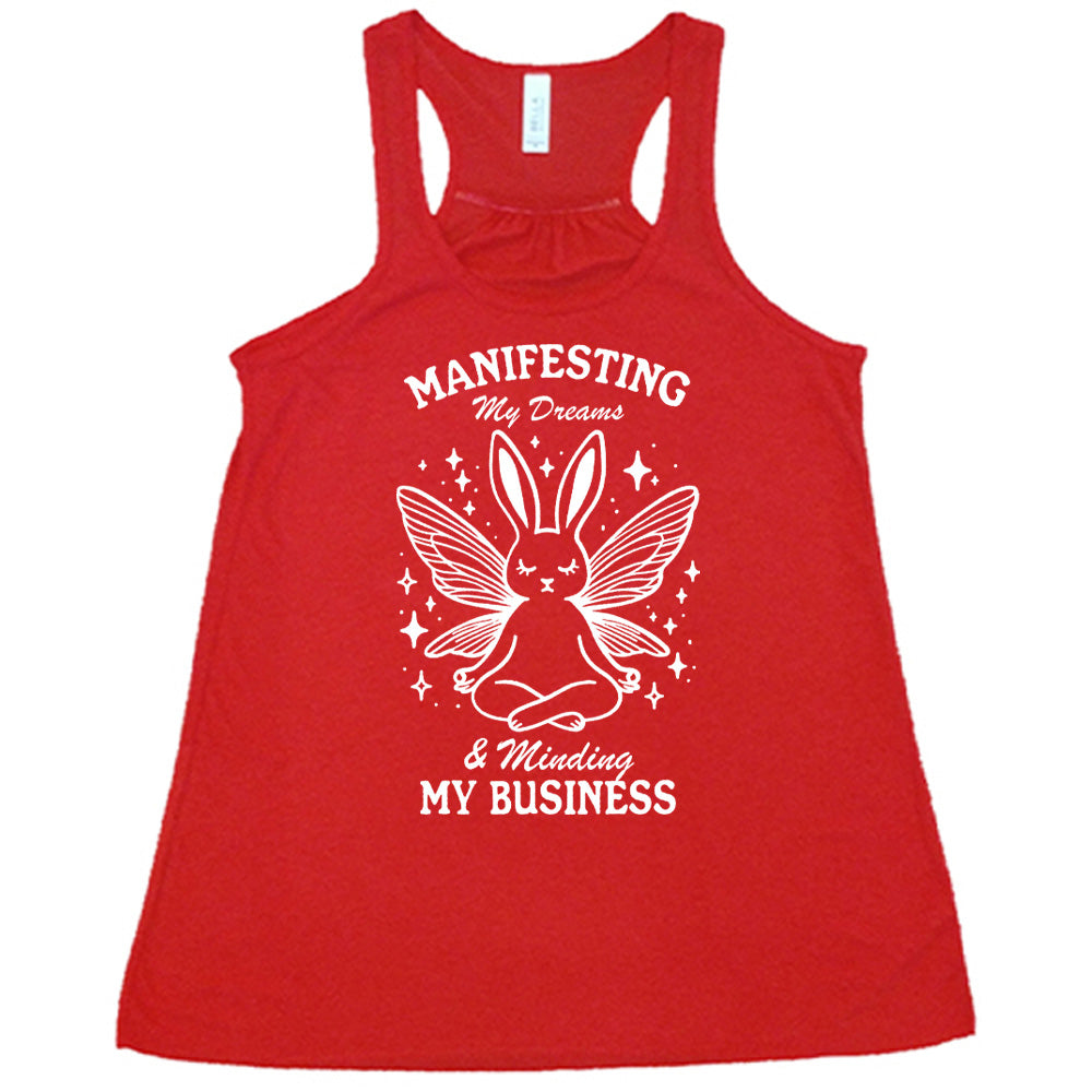 Red flowy tank with the words "Manifesting My Dreams & Minding My Business" and the graphic of a meditating rabbit with butterfly wings