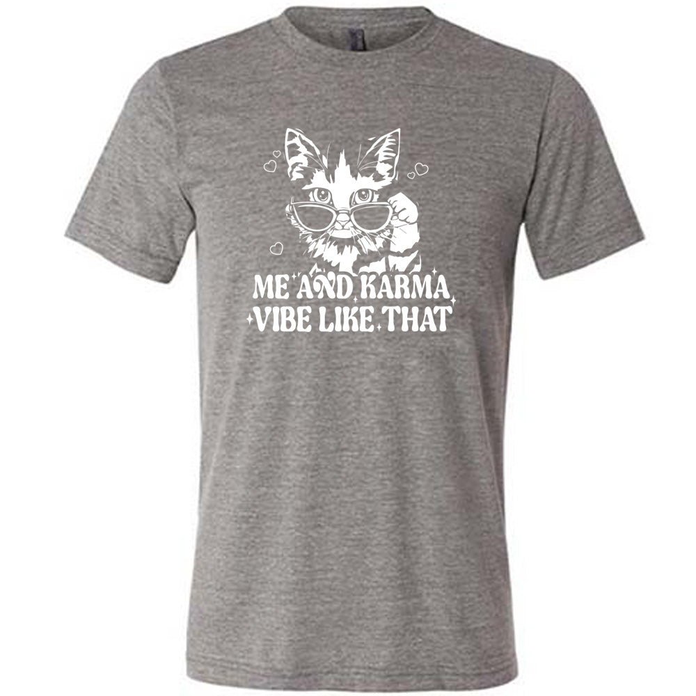 Grey colored shirt with a cat wearing sunglasses graphic on it that says "Me and Karma Vibe Like That" 